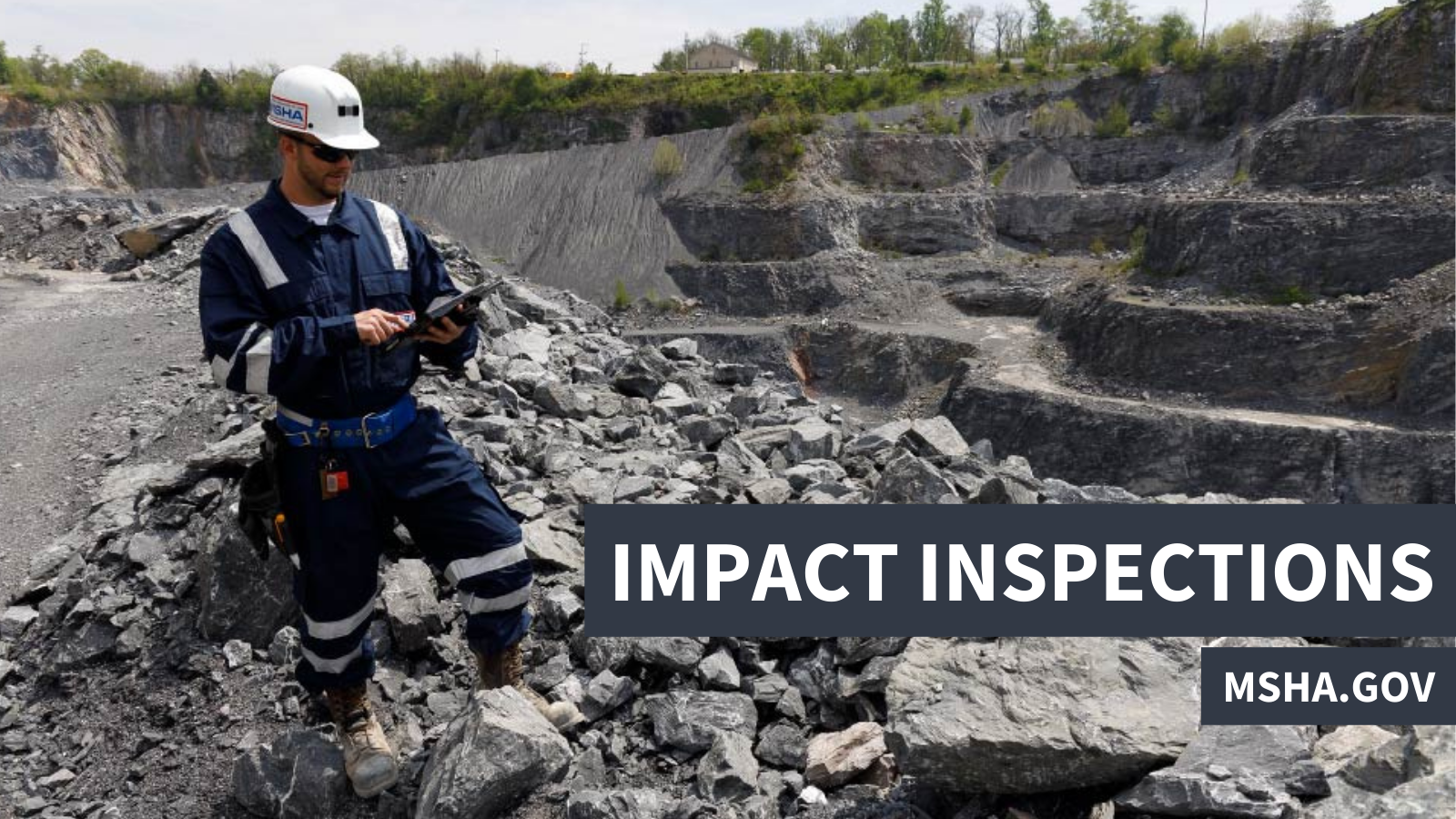 An MSHA inspector uses a tablet while standing on a pile of rocks at an outdoor mining site. &quot;Impact inspections, msha.gov&quot;
