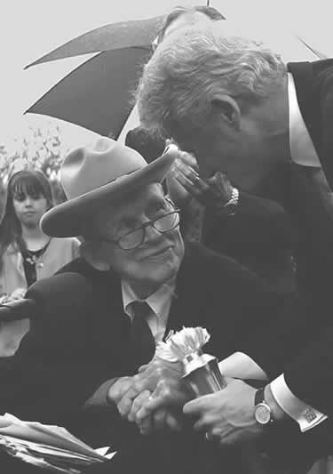 Justin Whitlock Dart, Jr. shaking President Clinton's hand.