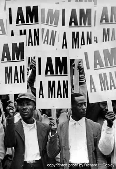 Group of black men holding signs reading I AM A MAN.
