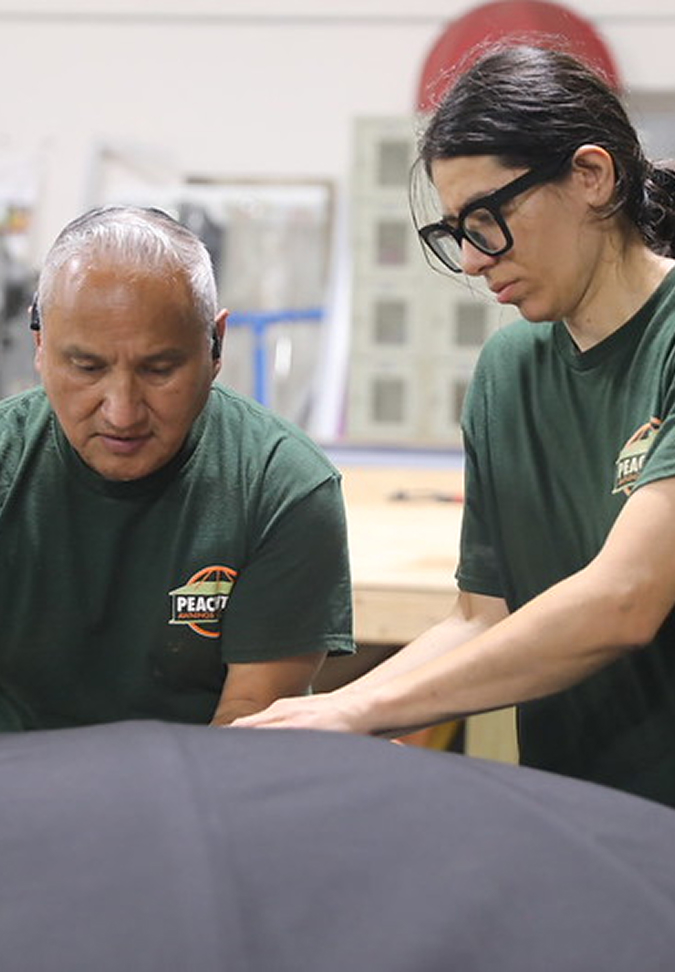 Two people reviewing materials together in a workshop setting