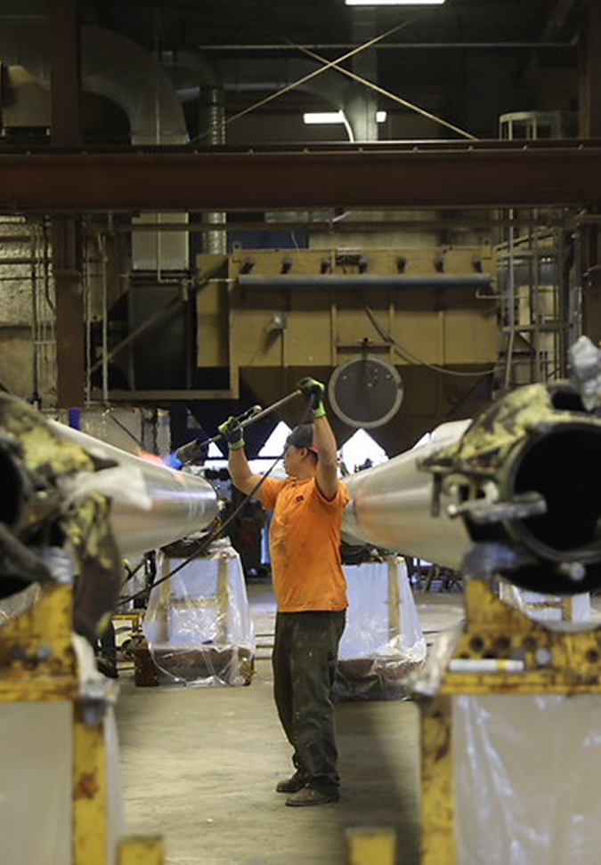 Worker in a factory handling large equipment