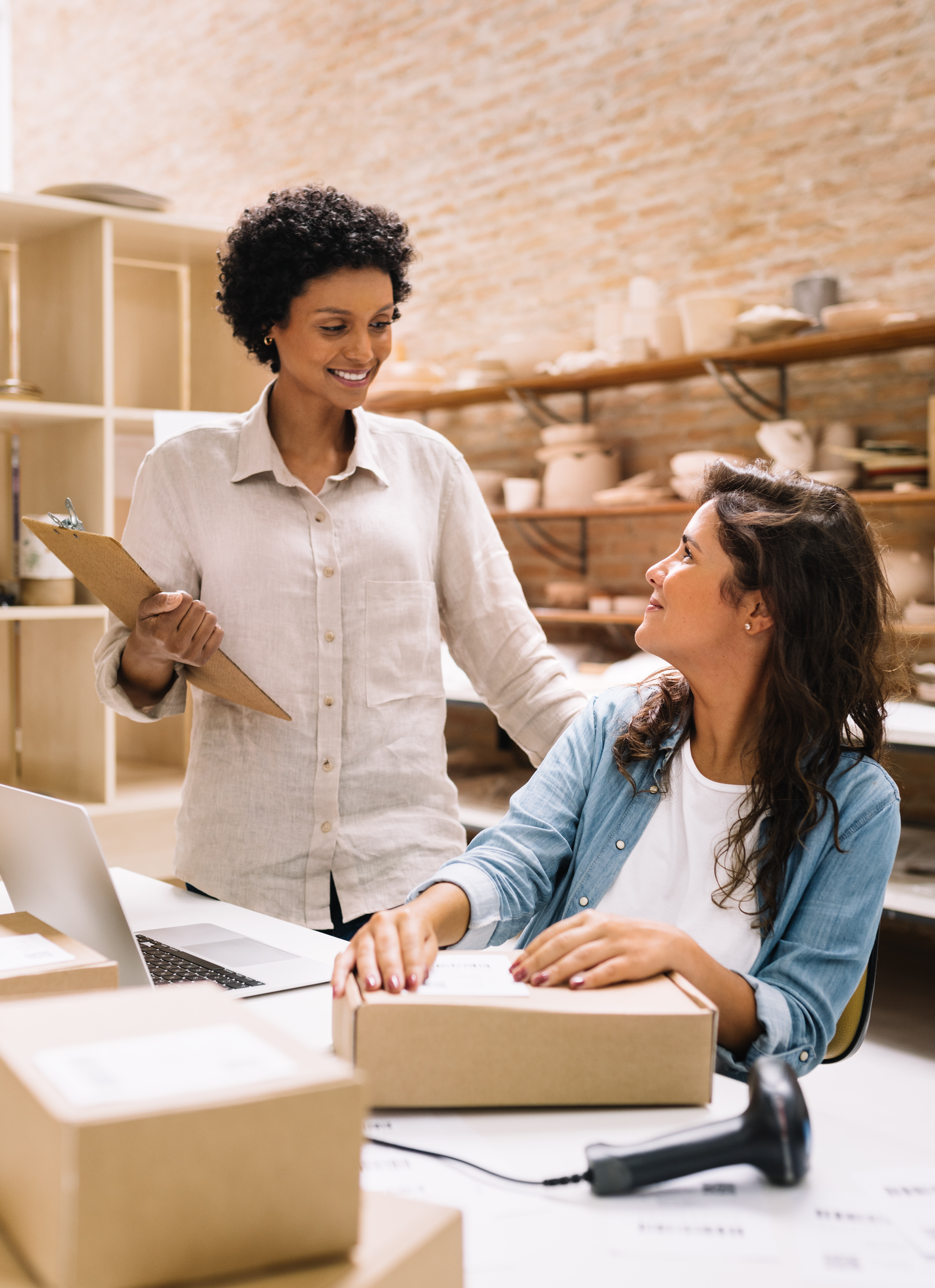 Two women talking at a desk