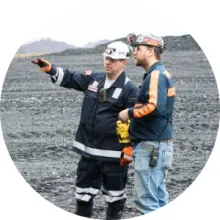 An MSHA employee talks with a miner at an outdoor site
