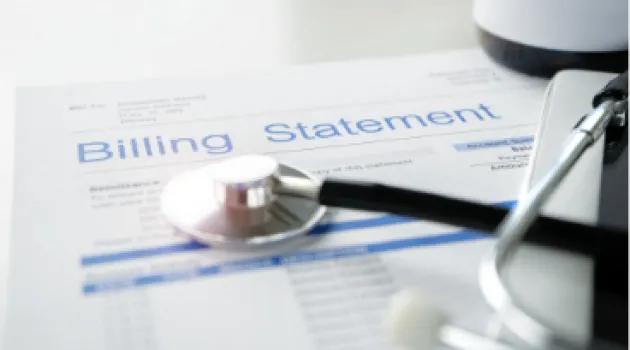 A stethoscope resting on top of a billing statement