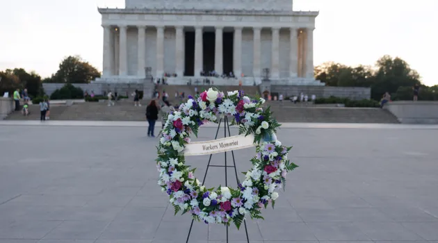 A wreath with the words "Workers Memorial" in front of the Lincoln Memorial in Washington, D.C.