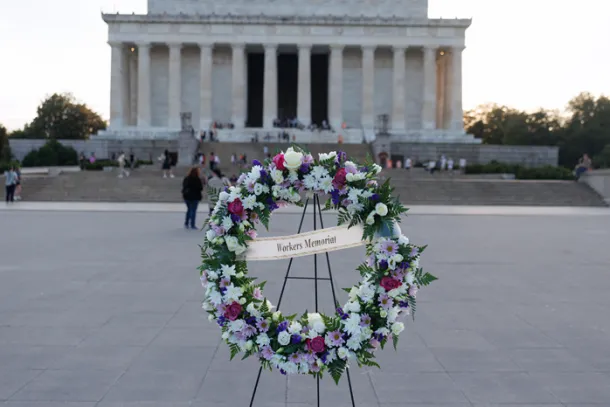 A wreath with the words "Workers Memorial" in front of the Lincoln Memorial in Washington, D.C.