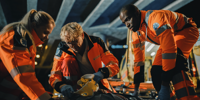 A group of EMS responders in orange suits. 