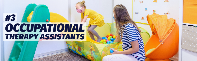 A woman coaches a preschool-age girl through a play area that includes a ball pit and small slide. "Number 3: Occupational therapy assistants"