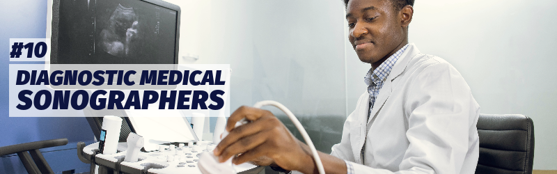 A man wearing a white lab jacket over a button-down shirt holds a sonography device displaying the image of a fetus on a large screen. "Number 10: Diagnostic medical sonographers"