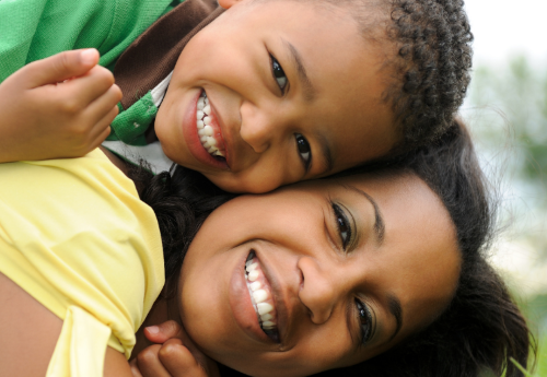 Son and mother cheek to cheek smiling