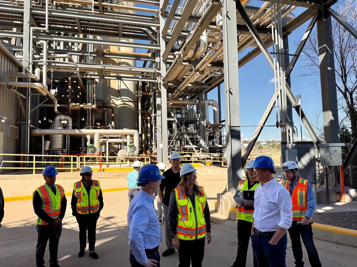 OSHA representatives tour an energy plant with workers and management.