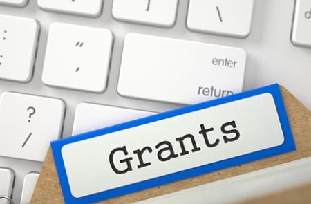 The word "Grant" overlaying a keyboard