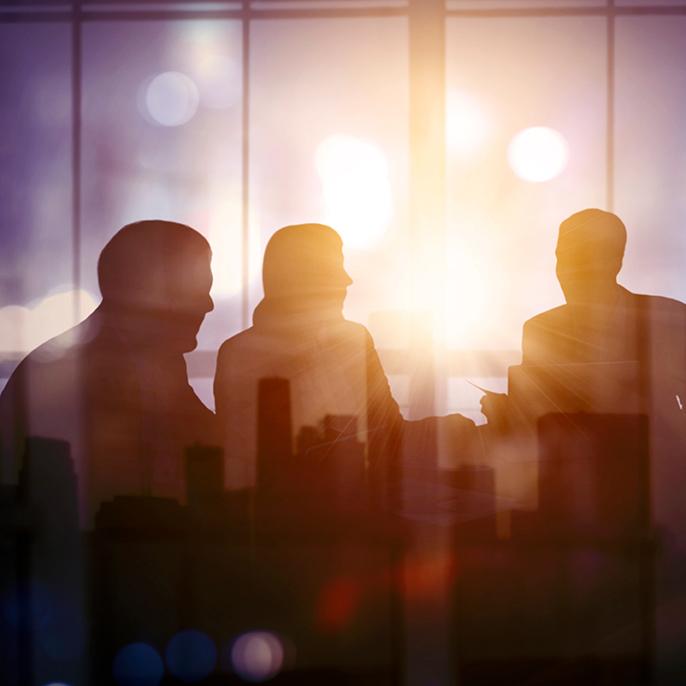 Silhouettes of business people in a meeting.