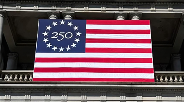 Freedom 250 flag in front of a building