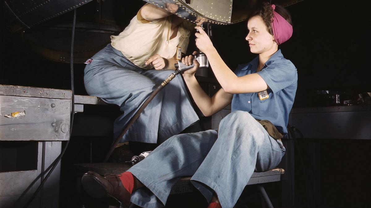 Two riveter women working together