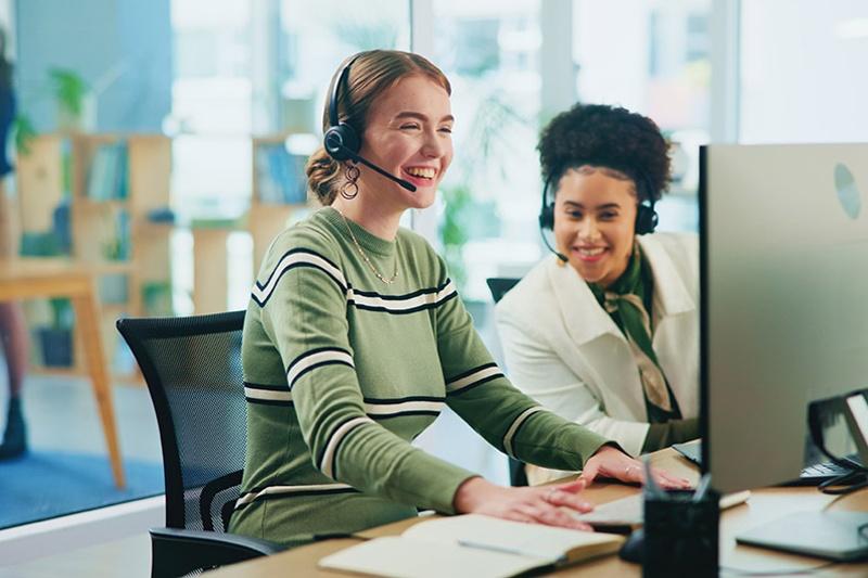 Two women looking at a computer monitor