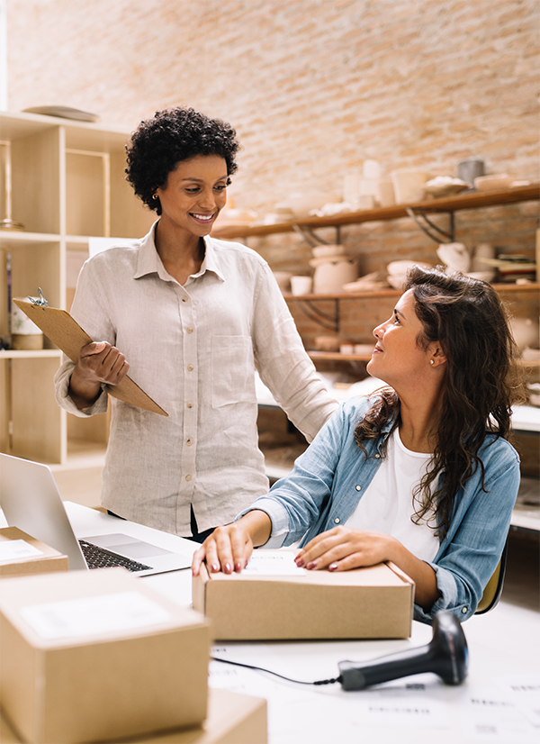 Two women talking at a desk