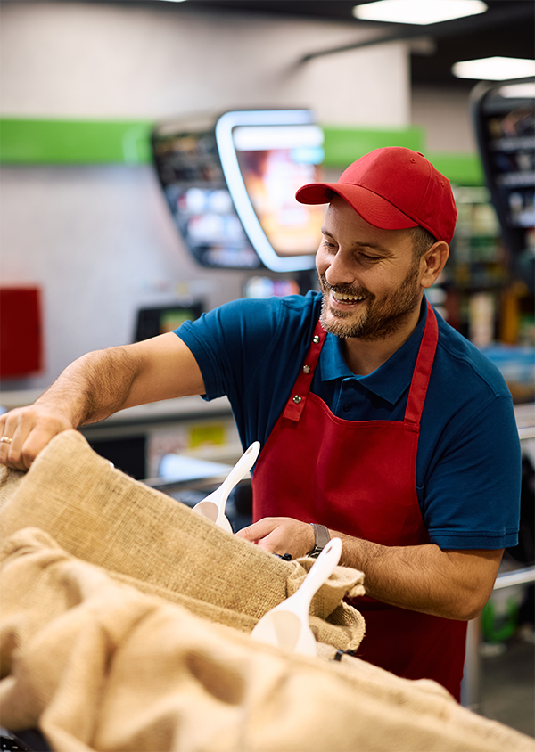 A man in a red hat and red apron working