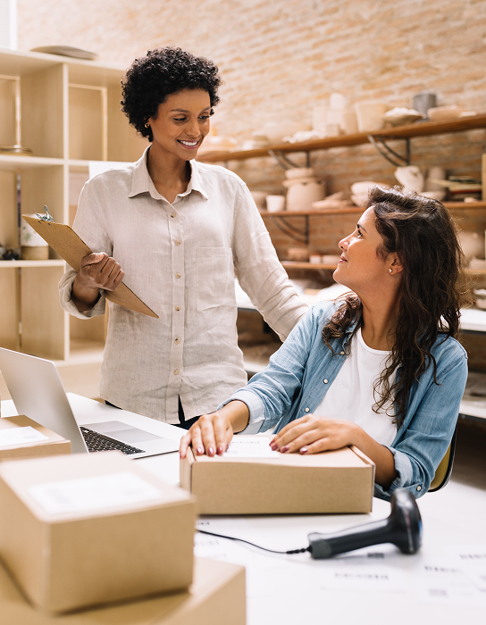 Two women talking at a desk