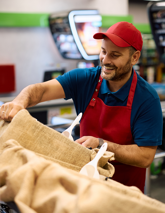 A man in a red hat and red apron working